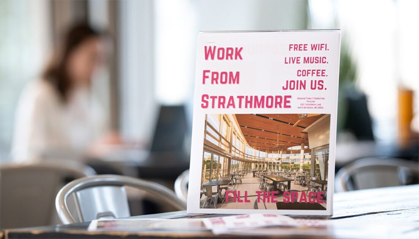 Work From Strathmore Sign With Workers In The Background