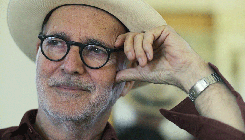 Ludovico Einaudi In A Beige Hat And Brown Shirt