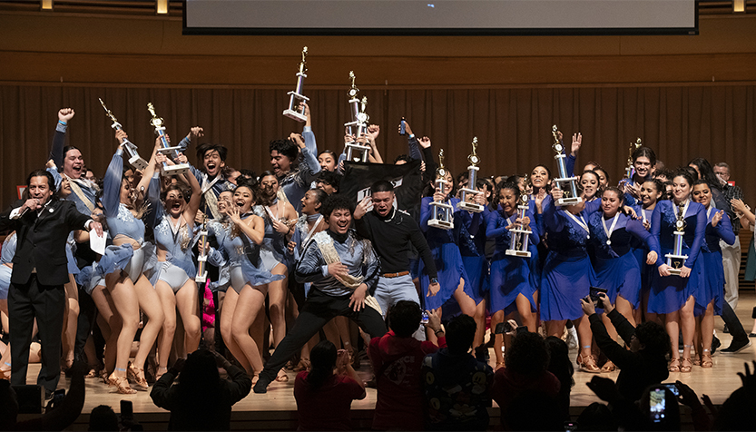 Baila4life Dancers Holding Trophies On Stage