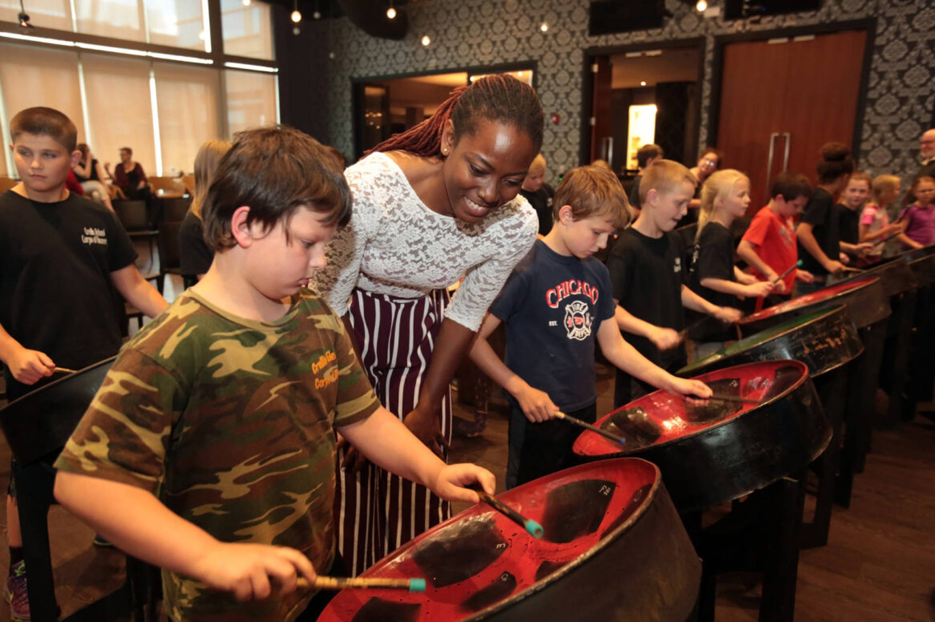 Josanne Francis Helping A Student Play The Steelpan