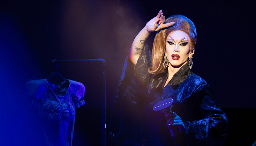 Sasha Velour Performing In A Robe While Holding A Steamer