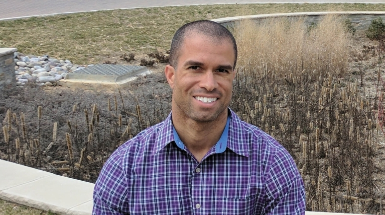 Kahlil Kettering In A Blue Checked Shirt In Front Of A Field