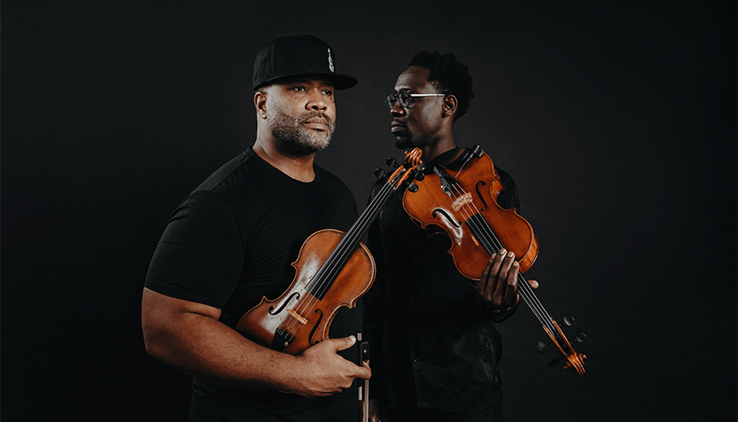 Black Violin Duo Wearing Black Tees And Holding Their Instruments